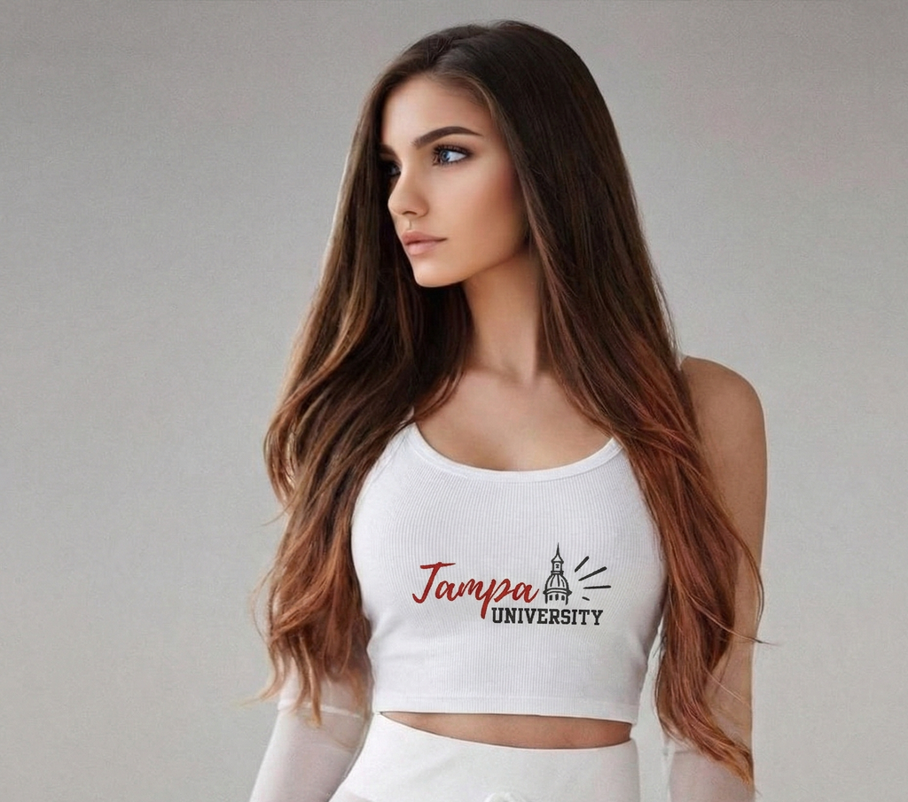 Woman wearing a white crop top with 'Tampa University' print on a plain background